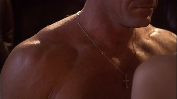 Johnson wearing a metallic purple dress with teased blonde hair