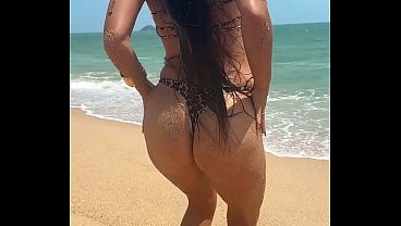 Sexy bikini dancing on the sunny tropical beach