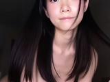 Black-haired asian babe strokes huge bushy dick in bedroom
